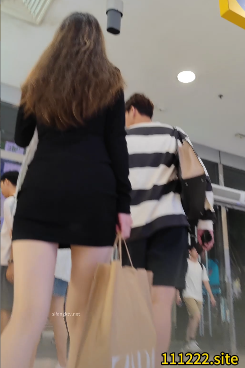 black short dress with long leg in the street